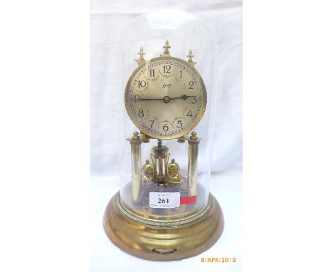 Schatz steel and brass dialed mantel clock on circular base within glass domed case