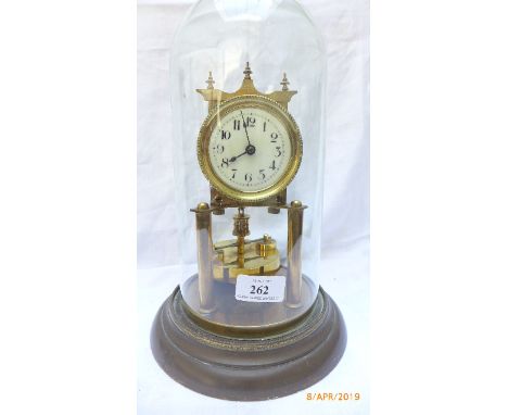 Brass and enamel mantel clock on circular brass base within domed glass case