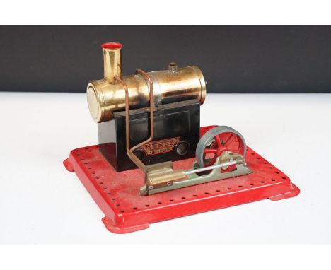 Steam Engine - Mamod stationary steam engine with red base, cylindrical engine with turning wheel, mechanism in working order