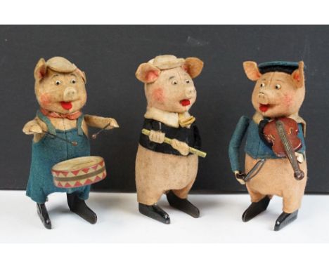 Set of original Schuco tin plate clockwork Three Little Pigs playing instruments, all with hats and instruments, figures grub