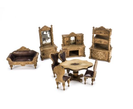 A German dolls’ house oak saloon set 1880s, With embossed cardboard decoration comprising sofa —4in. (10cm.) wide, four chair