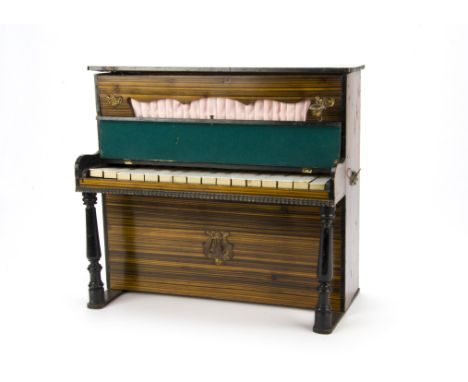 A toy/doll’s upright piano circa 1900, Of grained wood, brass carrying handles, candle sconces, turned ebonsied supports, bon
