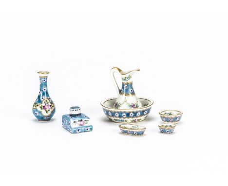 A French dolls’ house porcelain wash set,  Comprising jig -1½in. (4cm.) high, basin and three dishes, floral on a white and b