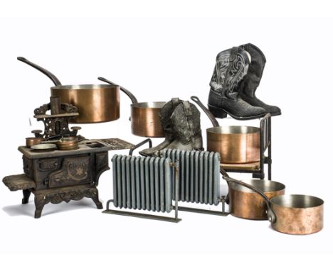 A quantity of props from puppets and stop-frame animation, Two pairs of child’s cowboy boots, two well-made cast metal radiat