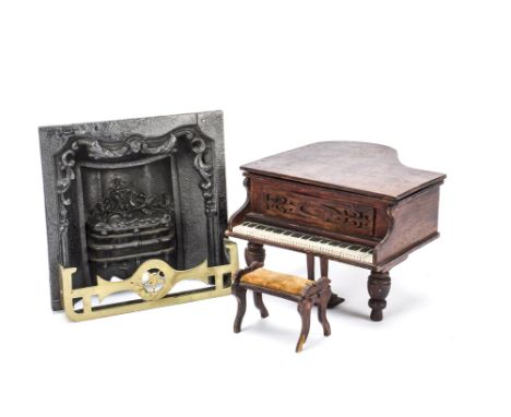 A cast-iron sample fire grate, With ornate fire basket and scrolling surround —7½in. (19cm.) high (old repair to top); a bras