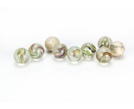 Antique marbles, Seven large hand blown marbles with multicoloured swirls and slightly rough pontil end —1¼in. (3.5cm.); two 