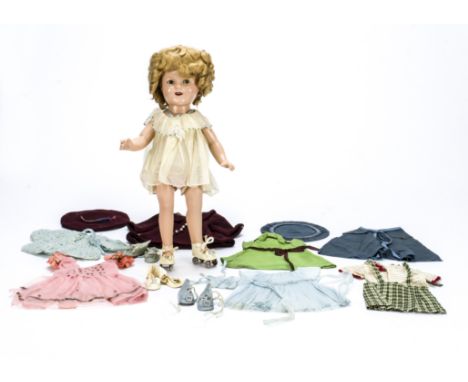 An Ideal composition Shirley Temple doll,  With blue sleeping eyes, blonde mohair curly wig, composition straight legged body