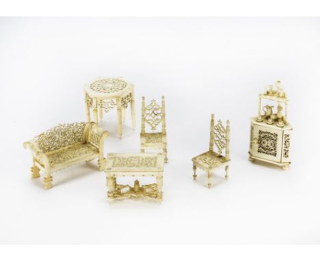 Late 19th century small scale bone dolls’ house furniture, Comprising sofa —2?in. (6.5cm.) wide, two chairs, a table and corn