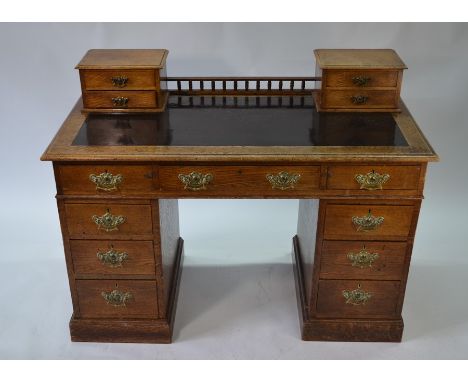 A Victorian oak pedestal desk with gallery back top over an arrangement of nine drawers, on plinths (123 cm w x 60 cm x 92 cm