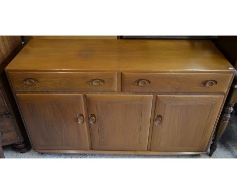 An Ercol elm sideboard with two drawers over three cupboard doorsgood condition