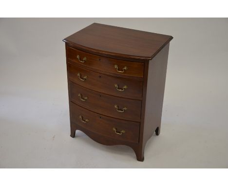 A small mahogany bowfront chest of four drawers raised on shaped feet, 59 cm wide x 43 cm deep x 75 cm high