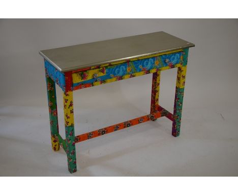 A fabric-covered console table, the lacquered silvered top above a long frieze drawer, 100 cm wide, 37 cm deep, 76 cm tall