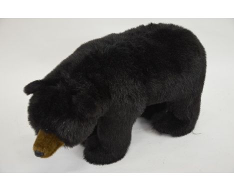 A large standing stuffed black bear toy by Ditz, 40 cm high x 75 cm long