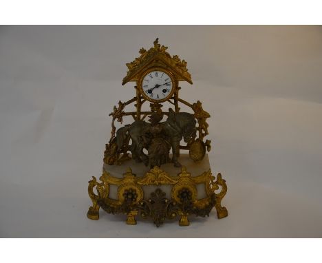 A Continental spelter and alabaster garniture mantle clock featuring horse and market seller beneath a portico, white dial an