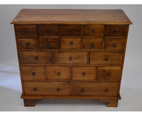 An Indonesian hardwood apothecary chest with arrangement of 19 small drawers, 95 cm high x 105 cm wide x 41 cm&nbsp;