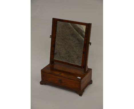 An Edwardian toilet mirror of diminutive proportions, the rectangular swing mirror above a single drawer raised on shaped bra