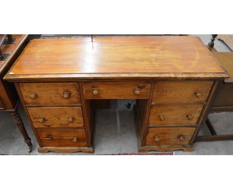 An old stripped pine kneehole desk with seven drawers (A/F)