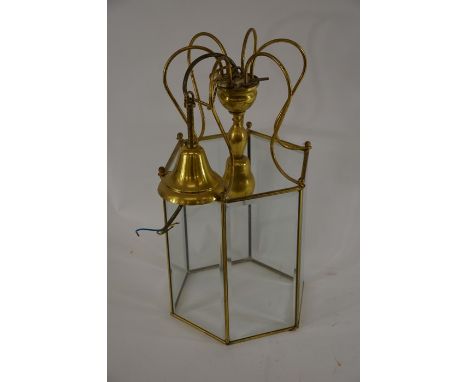 A brass octagonal hanging lantern with bevelled glass panels