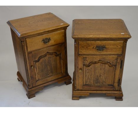 A pair of oak bedside cabinets each with a single drawer over a panelled cupboard, raised on bracket feet