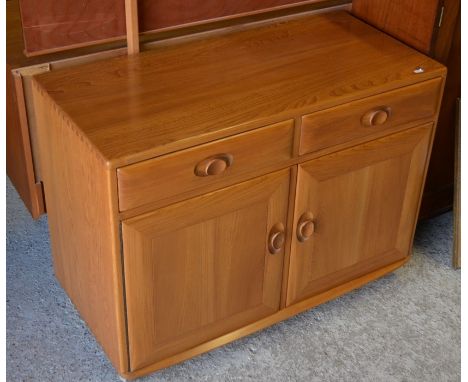 A mid century Ercol elm side cabinet with two drawers over panelled cupboard doors on castors 91 cm wide x 43 cm deep x 68 cm