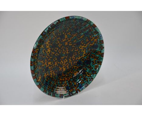 Alan White Studio, Poole - A large pottery charger, turquoise ground, decorated overall with an organic abstract ochre and bl