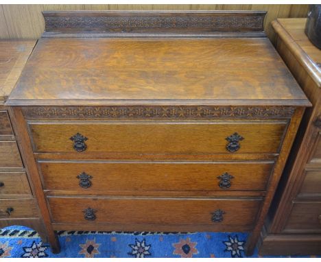 A carved oak chest of three long drawers with gallery, 86 cm wide x 77 cm high x 45 cm deep