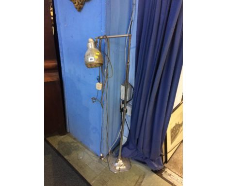 A chrome angle poise lamp