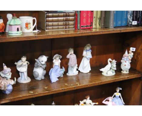 Two Lladro clowns, Lladro duck group and five Nao figures (8)