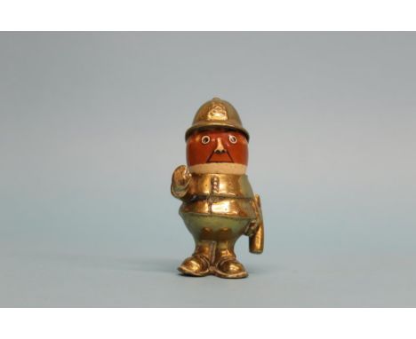 A John Hassall brass and ceramic policeman car mascot, circa 1910, signed on the waist, 11cm tall