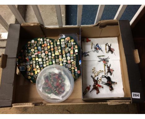 A collection of enamel badges and lead soldiers