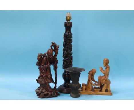 A carved rosewood figural table lamp, a root man figure etc.