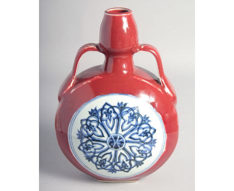 A CHINESE IRON-RED TWIN HANDLED MOON FLASK decorated with central blue and white yin-yang medallion, with eight-pointed star 