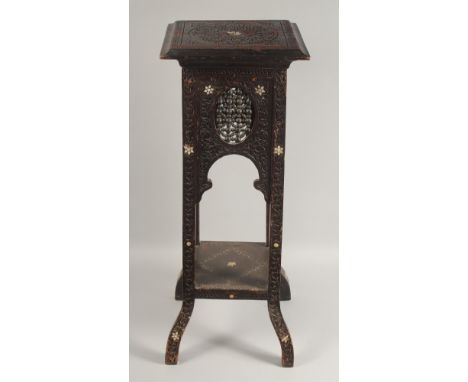 A MOORISH TALL CARVED HARDWOOD STAND, with mother of pearl inlay and mashrabiya panels above a lower under tier, 90cm high.