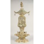 A TALL EAST ASIAN FOUR-PIECE BRASS LANTERN, in the form of a bird cage upon a figural base of