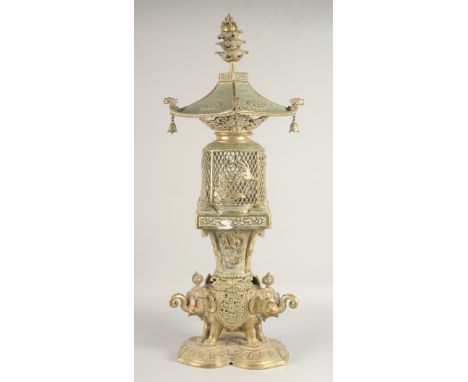 A TALL EAST ASIAN FOUR-PIECE BRASS LANTERN, in the form of a bird cage upon a figural base of elephants; comprising an interl