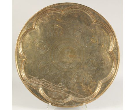 A FINE, LARGE 19TH CENTURY PERSIAN QAJAR ENGRAVED BRASS TRAY, the centre engraved with portrait and inscribed. 57.5cm diamete