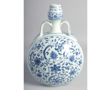 A CHINESE BLUE AND WHITE PORCELAIN TWIN HANDLED MOON FLASK painted with various flower heads and scrolling vine, bearing six-