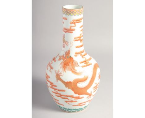 A CHINESE CORAL RED AND WHITE PORCELAIN VASE, painted with a dragon chasing the flaming pearl of wisdom in gilt highlights, s