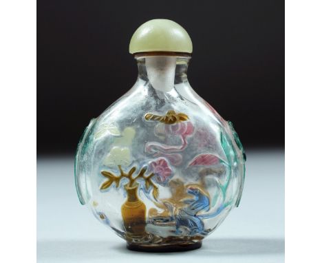 A SUPERB CHINESE ROCK CRYSTAL SNUFF BOTTLE AND JADE STOPPER, with carved and stained decoration depicting flora and fauna, wi