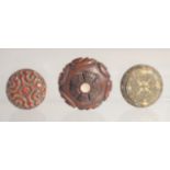 THREE SMALL CIRCULAR BOXES; comprising a carved hardwood box with mother of pearl inset, a red