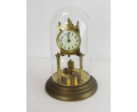 A 20th Century 100 day clock with a white enamel dial on a circular brass base