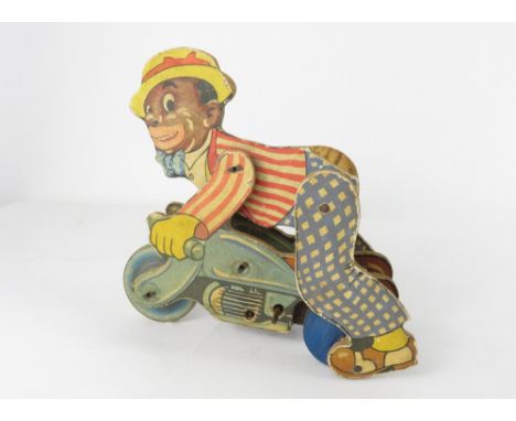 A Chad Valley clockwork wooden toy of a man on a motorbike and having printed paper details, circa 1930's