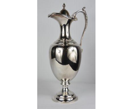 A silver ewer, by Roberts and Belk, Sheffield 1971, of classical pedestal form, hinged cover with finial, leaf capped scroll 