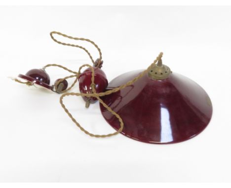 A rise and fall red coloured ceramic pendant electric light, with original Terre d' Hautaniboul label