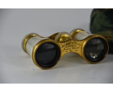 A pair of Victorian mother of pearl and lacquered brass opera glasses with presentation inscription dated 91, in leather case