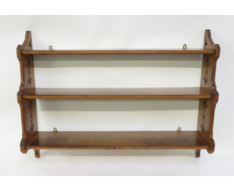 An early 20th Century oak hanging shelf, with pierced side panels, 80cm high, 107cm long, 21cm deep