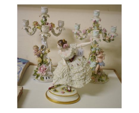 A Continental porcelain figure, of a dancing lady wearing a dress, 30 cm high, and a pair of Continental porcelain figural fo