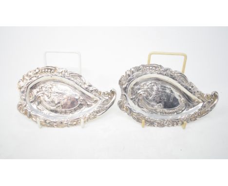 Two matching silver dishes, of shaped form, embossed a musician playing to a dog, London 1890, approx. 4.3 ozt, 15 cm wide (2