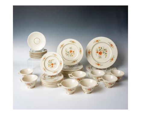 Cream-colored set for 8, decorated with red, yellow, blue, and white flowers and gold gilt trims. Includes 2 round platters (