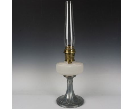 A beautiful lamp depicting a silvery-pewter base and a moonstone-white body with vertical grooves. Includes a narrow clear gl